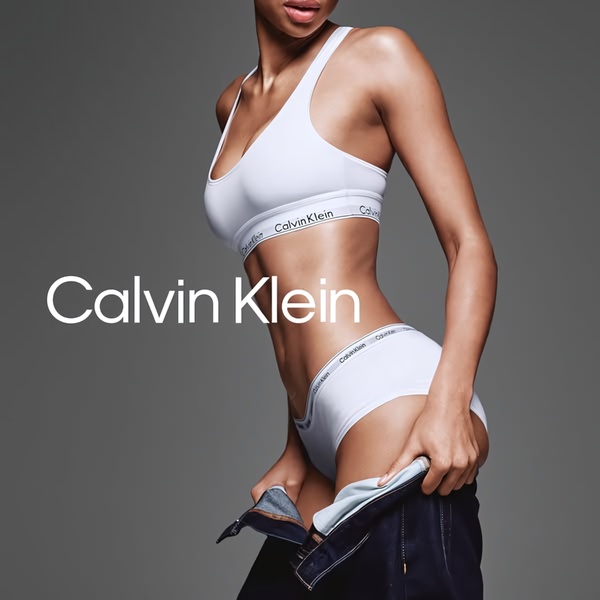 This square ad features a high-contrast, studio-lit shot focusing on a model wearing branded underwear, creating a clean and aspirational brand identity.